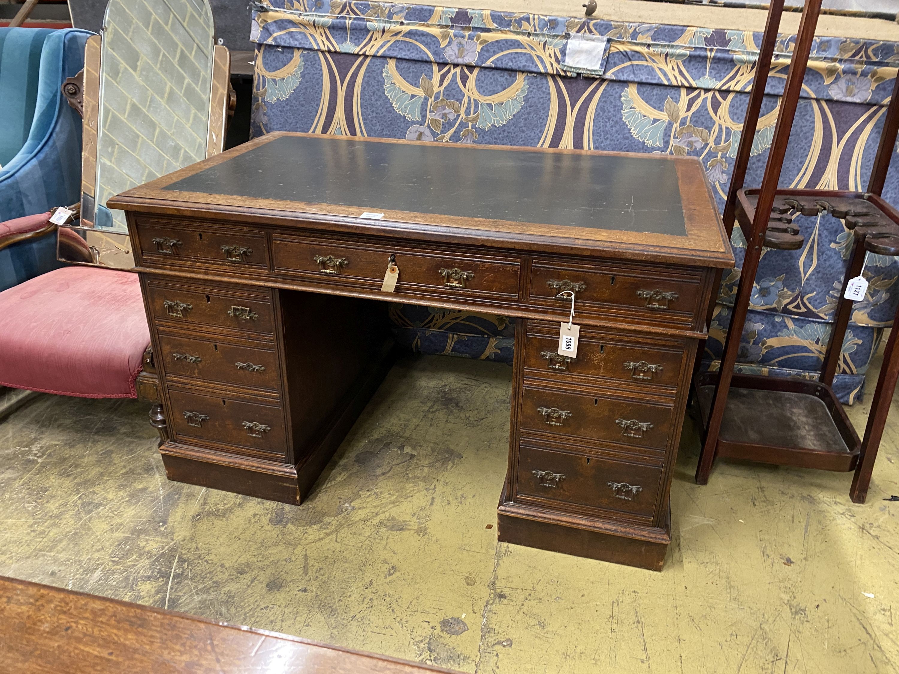 A late Victorian walnut nine drawer pedestal desk, length 122cm, depth 73cm, height 75cm